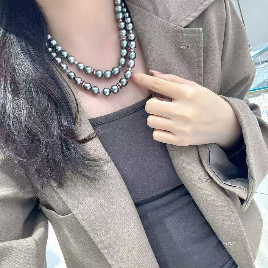 Double-layer Tahitian pearl and ruby necklace, 8.4–10.8mm pearls with mirror luster and 18K gold. A refined, layered statement piece.